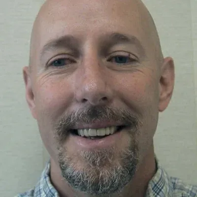 A smiling man showing off his dental work from Dr. Bjorklund.