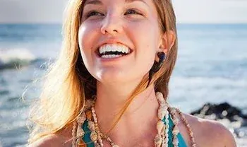 A smiling woman, from the practice's own general dentistry page.