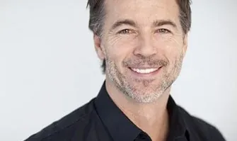 A man smiling after his smile was restored with dental implants.