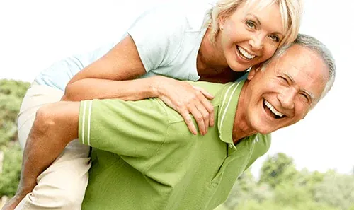 An older couple outdoors, from the practice's own page on laser dentistry.